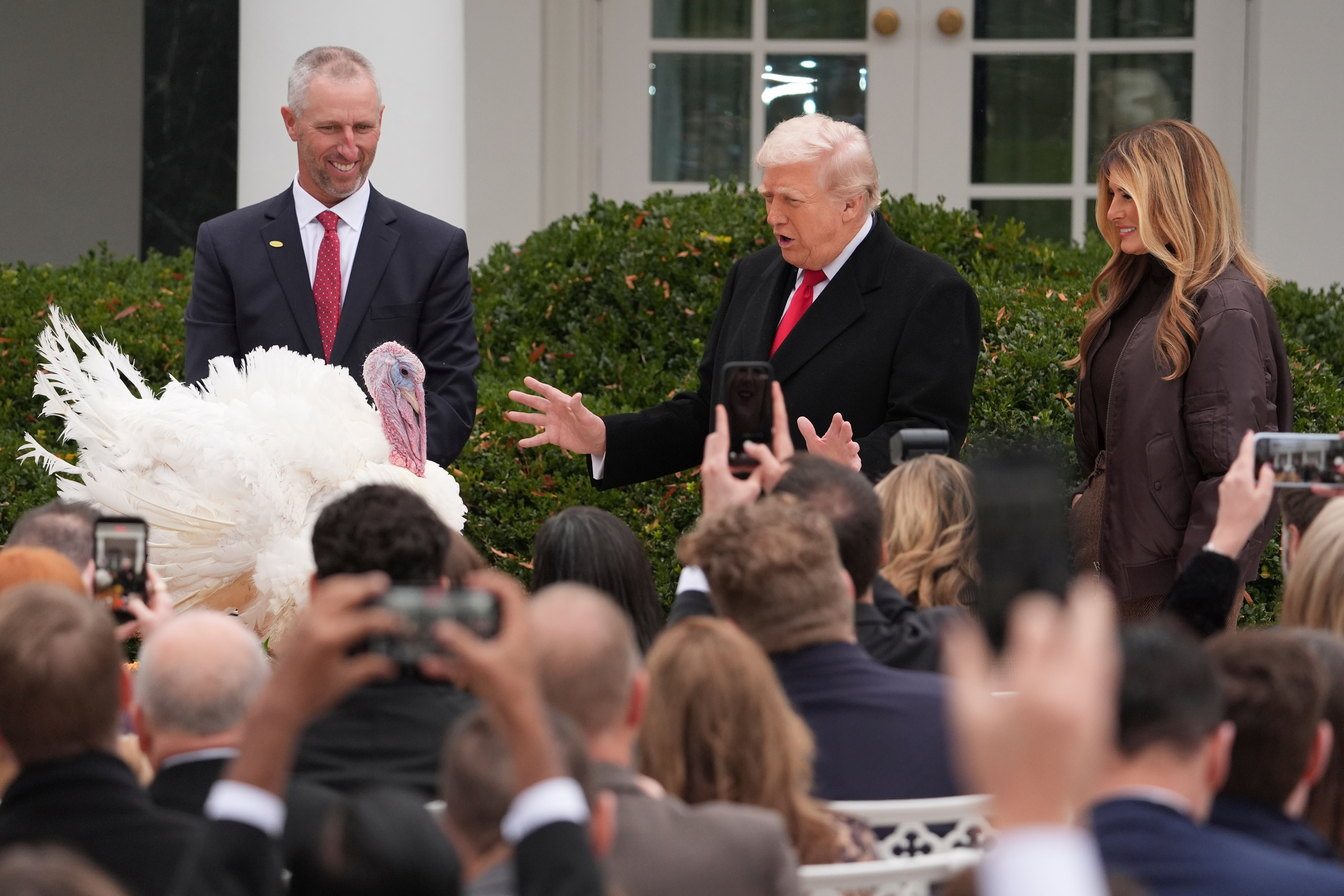 President Donald Trump and first lady Melania Trump, stand next to national Thanksgiving turkey Gobble during a pardoning ceremony in the Rose Garden of the White House, on Tuesday, in Washington.
